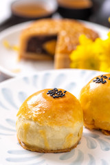 Tasty baked egg yolk pastry moon cake for Mid-Autumn Festival on bright cement table background. Chinese traditional food concept, close up, copy space.