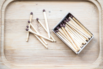 Box with matches on a wooden background