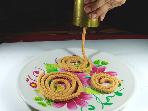 Traditional Indian snack chakli Making. Raw Chakli