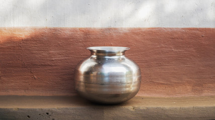 Fototapeta Metal pot in a village used for storing water. Photos of village life and everyday life. obraz