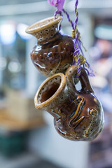 ceramic Souvenirs in the form of jugs are hung on a ribbon