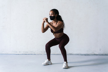 Obraz premium Photo of athletic african american woman in face mask doing exercise