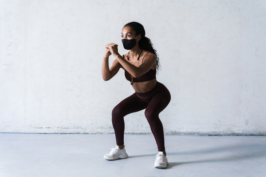 Photo Of Athletic African American Woman In Face Mask Doing Exercise