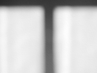 shadow on white wall with light from the window in the room