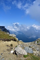 Fototapeta premium fluffy white clouds among the mountain ridges. mist at high altitude