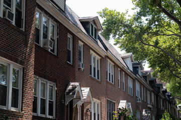 Fototapeta premium Row of Beautiful Similar Brick Homes in Sunnyside Queens New York