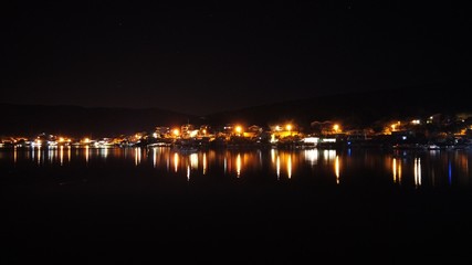 Night scene with light and reflection at Balikliova, Urla, izmir, Turkey.