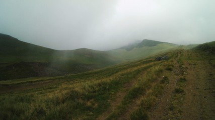 fluffy white clouds among the mountain ridges. mist at high altitude