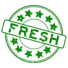 Grunge green fresh word with star icon round rubber seal stamp on white background