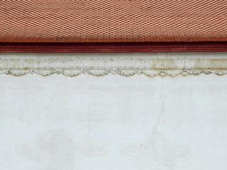 ancient white concrete wall of chapel in temple at Wat Prasat Nonthaburi, Thailand