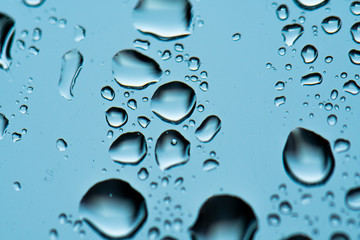 Macro raindrops vapor on window glass. Rain drops on window glasses surface. Through the window view. Drops of rain on glass. Water pattern texture
