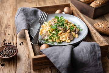 Scrambled eggs with mushrooms, onion and parsley