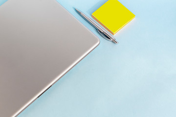 Quarantine, online training, work from home. Laptop, phone and pen, stickers and coffee in a...