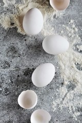 
several white eggs on a concrete background