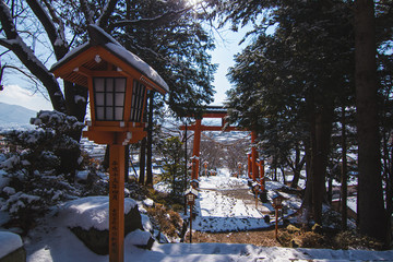 Japanese Trail Lamps by Large Japanese Gate.  Pole Translation:  April, Year 15 of Heisei, Yugengaisha Sogawa Newspaper Delivery