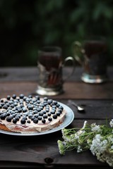 Fototapeta na wymiar pie with black currant berries on a wooden table