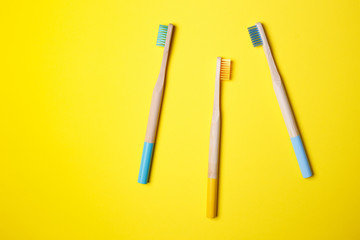 bright toothbrushes on a yellow background