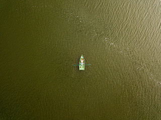 Aerial drone view. Fishing boat on the river on a summer day.