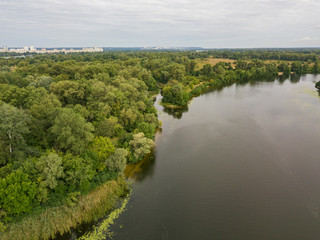 Fototapeta na wymiar Aerial view. Green bank of the Dnieper river on a summer day.