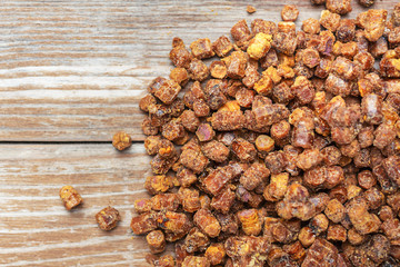 Beekeeping products. Bee bread  on a wooden background. Copy space. Top view. Alternative medicine. Healthy food concept.