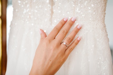 Close up of hands of woman showing elegant diamond ring on the finger, love and wedding concept. Engagement ring on bride's finger. Wedding day. Soft and selective focus.
