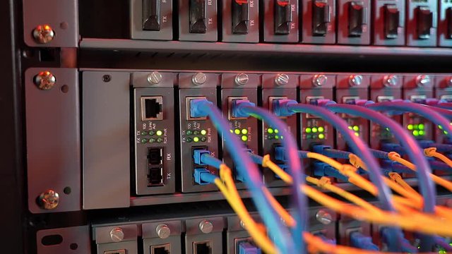 Fiber Optic cables connected to an optic ports and Network cables connected to ethernet ports