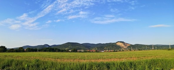 Landscape panorama with hills under blue sky