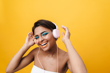 Image of african american woman listening to music with headphones