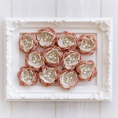 Artificial handmade flowers made out of beautiful fabric texture in soft brown color