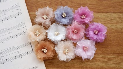 Artificial handmade flowers made out of beautiful organza fabric texture in pastel colors