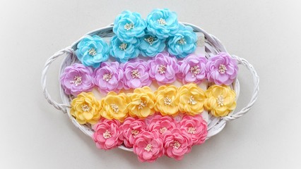 Artificial handmade flowers made out of beautiful fabric texture in pastel colors