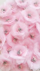 Artificial handmade flowers made out of beautiful organza and tulle fabric texture in soft pink color