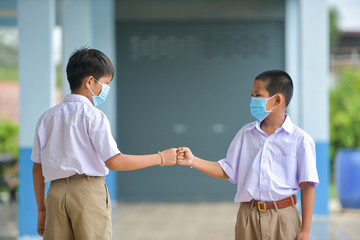 school kids with protection face mask against flu virus at lesson in classroom