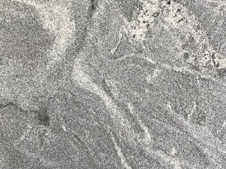 The stone texture or background.