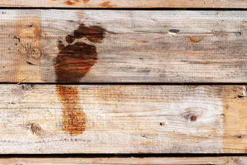 wet footprint on wooden boards. the texture of the boards