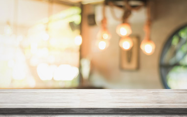 Empty wooden table top with lights bokeh on blur restaurant background