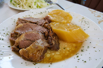 Traditional Balkan dish - meat stewed in a special pot, sac, and served with kajmak cheese and stewed vegetables
