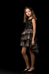 Beautiful young teen girl studio photo on black background