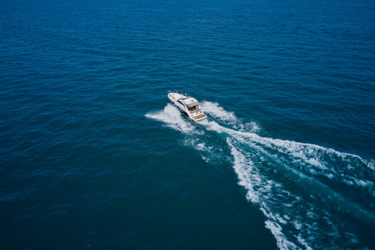 Top view of a white boat sailing to the blue sea. Motor boat in the sea.Travel - image