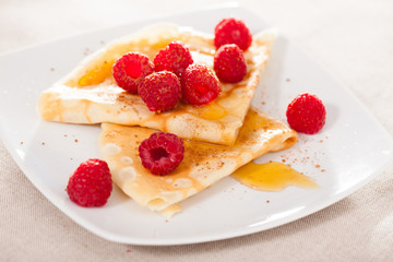 delicious  pancakes with fresh raspberries and honey