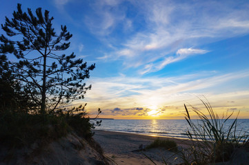 Sunset over the sea. Reflection of sunlight in the sea waves. The sky in the sunset rays.