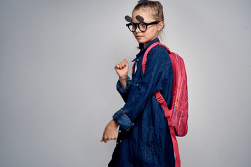 school girl with pink backpack swoosh pigtail fun learning light background school childhood