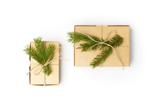 craft boxes with pine tree branches and natural rope isolated on white background © Maria Tatic