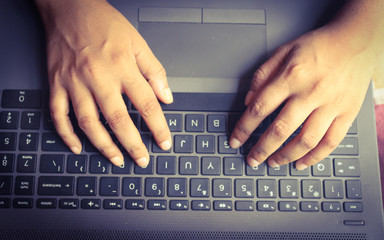 Fototapeta na wymiar typing on a laptop keyboard