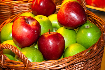 Wicker basket with red and green apples