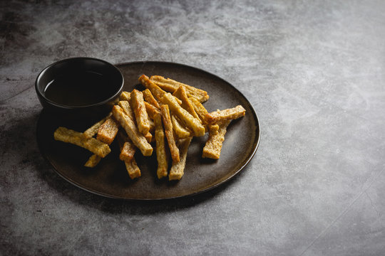  fried fish snacks called Keropok Lekor on concrete Background.