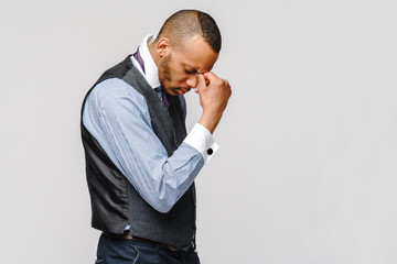 Young afro american businessman touching head because of headache and stress