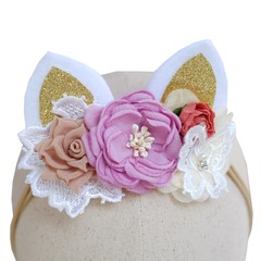 Handmade flowers as headband hair accessory with cat or kitty ears as decoration in soft pastel colors