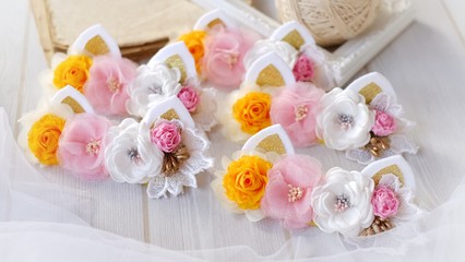 Handmade flowers as headband hair accessory with cat or kitty ears as decoration in soft pastel colors