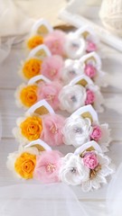 Fototapeta na wymiar Handmade flowers as headband hair accessory with cat or kitty ears as decoraiton in soft pastel colors